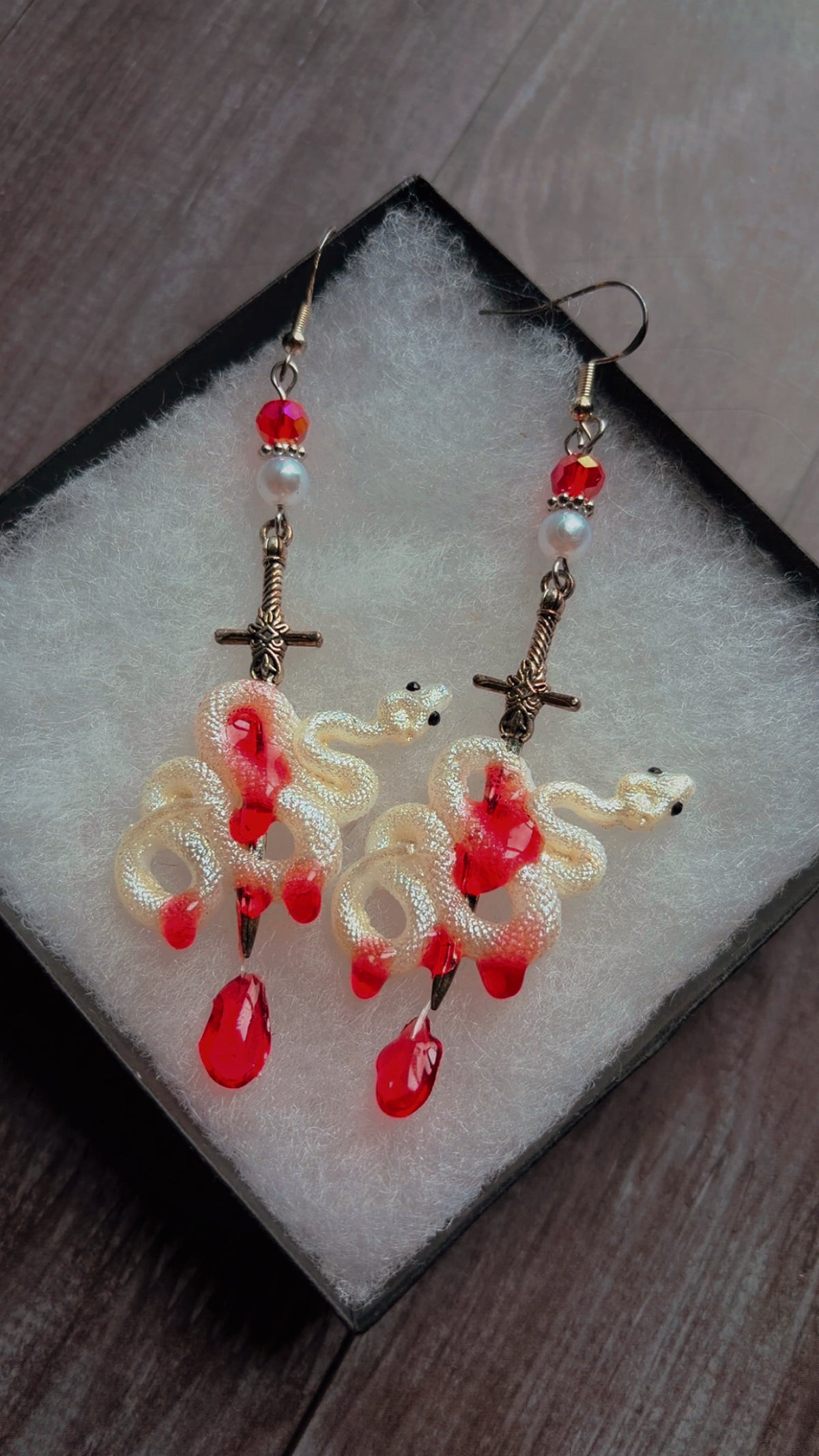 Handmade pearlescent horror snake and sword earrings