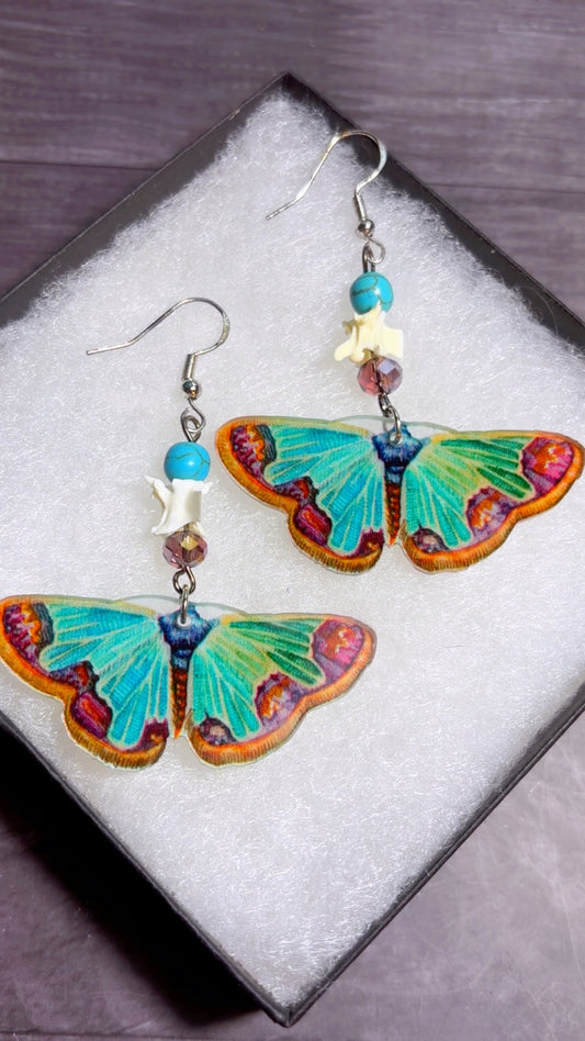 Handmade snake vertebrae earrings with moth charms