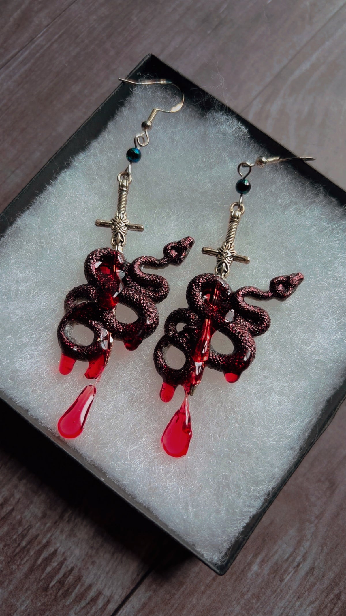 Handmade iridescent horror snake and sword earrings