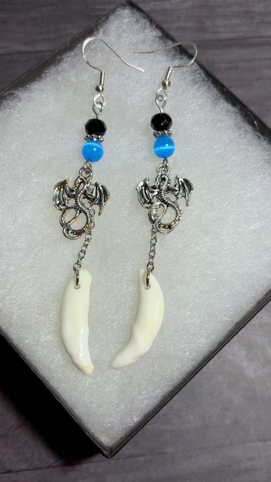Handmade coyote fang earrings with dragon charms
